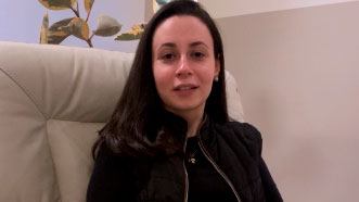Marcella está sentada em uma poltrona e dá seu depoimento sobre sua experiência com a hipnoterapia para depressão profunda